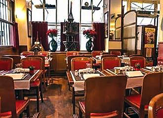 Tables and chairs inside Aux Charpentiers Bistro