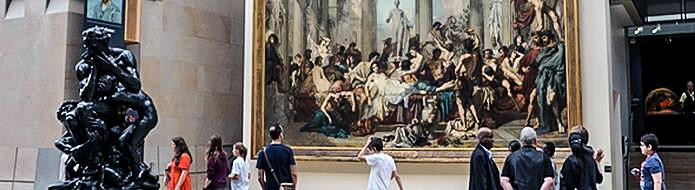 Tourists and large painting in Musee d’Orsay
