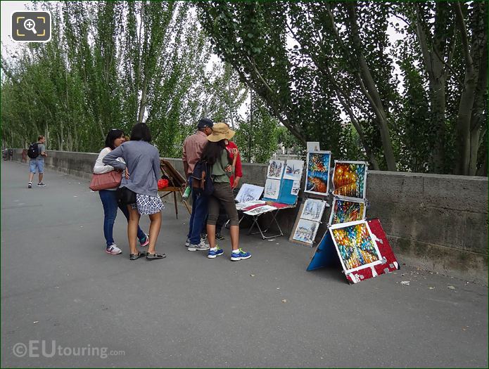 Paris artist selling paintings on Quai Francois Mitterrand