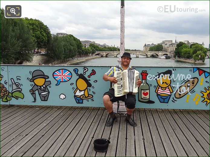 Street musician playing accordion on Pont des Arts