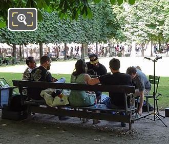 Group having music session in Jardin des Tuileries