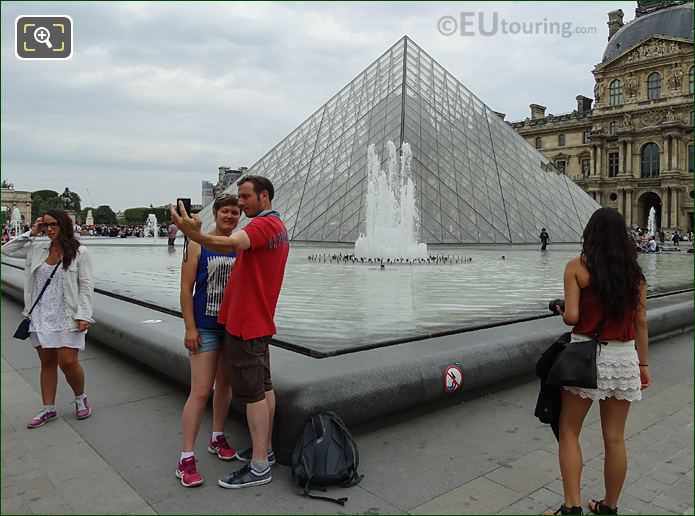 Couple taking selfie with Pyramid Musee du Louvre