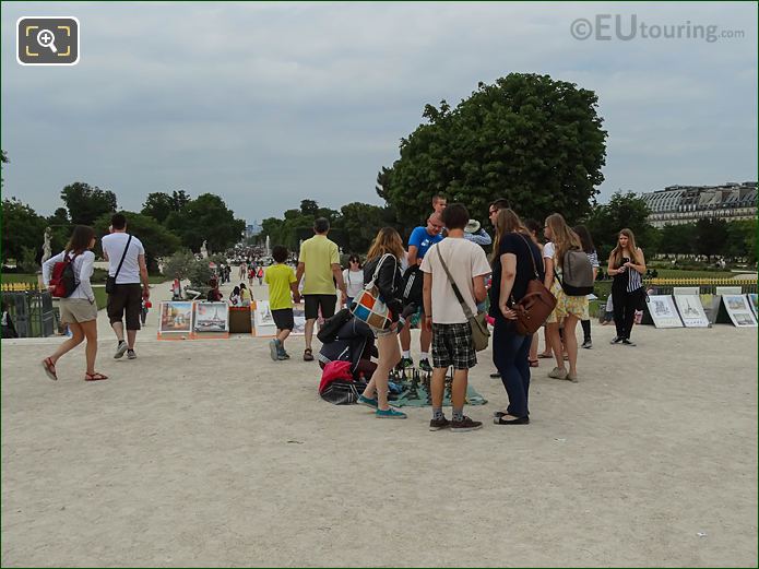 Tourists buying from street sellers at Tuileries Garden Paris