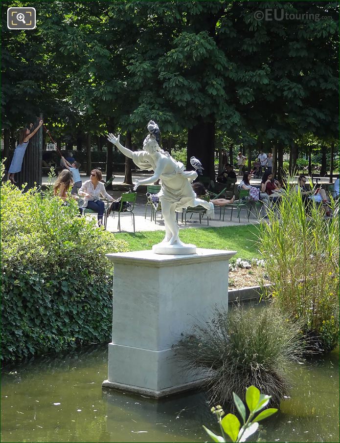 Daphne statue on pedestal in pond