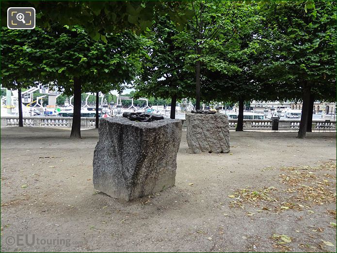 Two sets of hands on granite in Tuileries Gardens