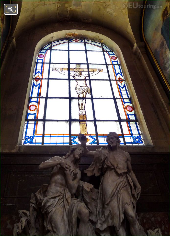 Baptism of Jesus statue with Eglise Saint-Roch stained glass window