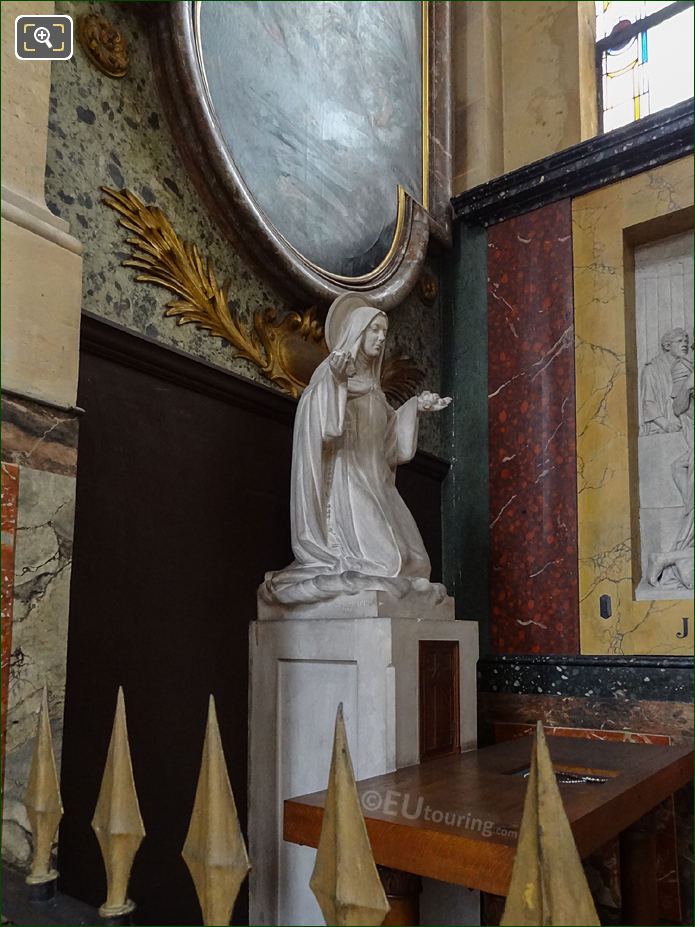 Saint Kneeling statue in the Eglise Saint-Roch in Paris