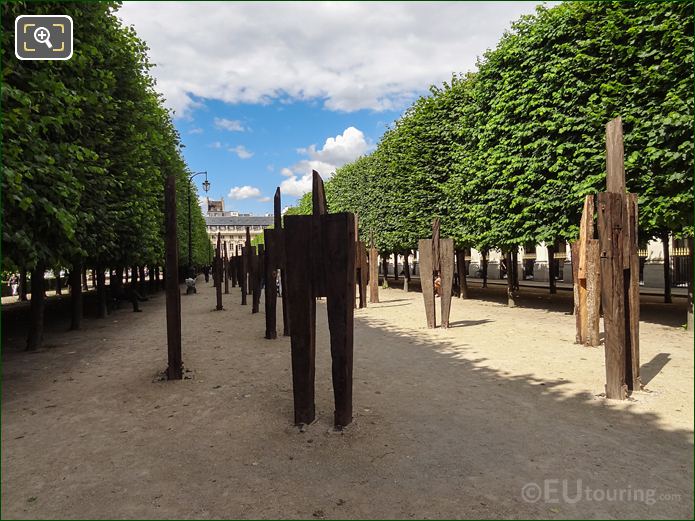 Rows of L'Homme Debout contemporary art sculptures in Palais Royal gardens