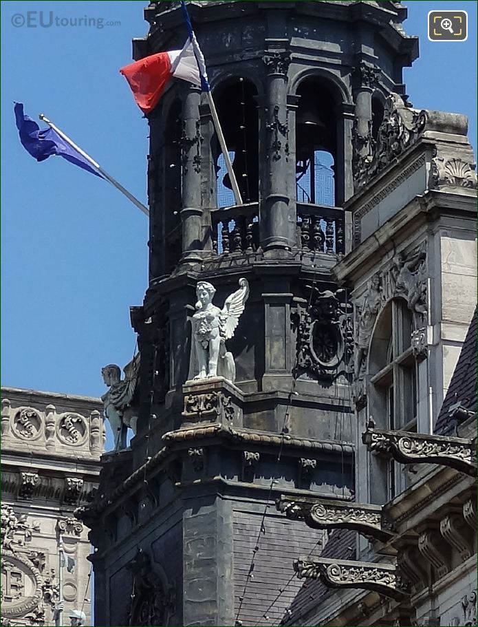 Winged statue next to bell tower on Hotel de Ville