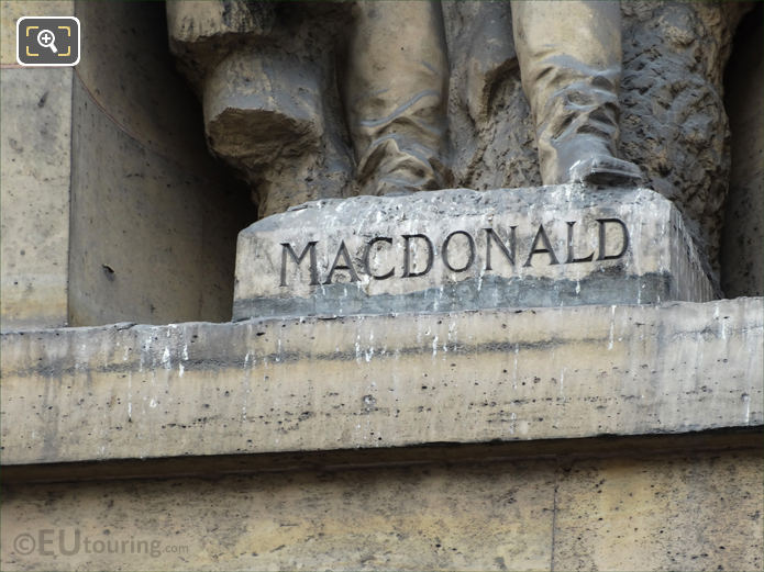 MacDonald inscription on statue pedestal within niche