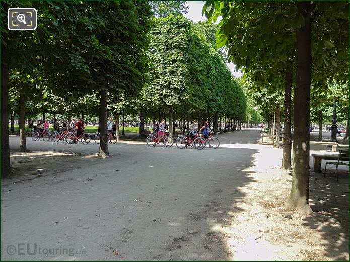 People on Paris bike tour walking through Jardin des Tuileries