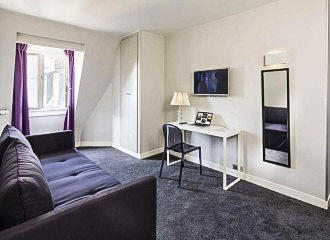 Hotel Paris Vaugirard bedroom lounge area