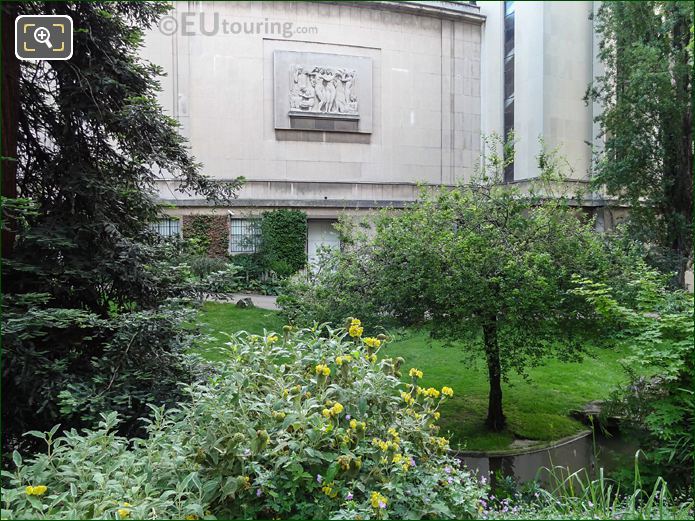 Passy Wing bas relief view through trees in Jardins du Trocadero