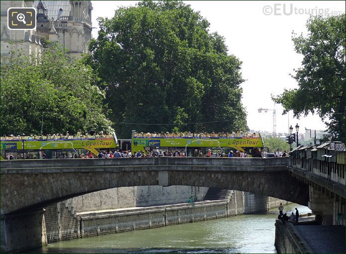 Two OpenTour buses over River Seine