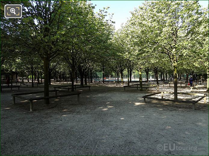 View through trees to Jardin du Luxembourg SW tennis courts