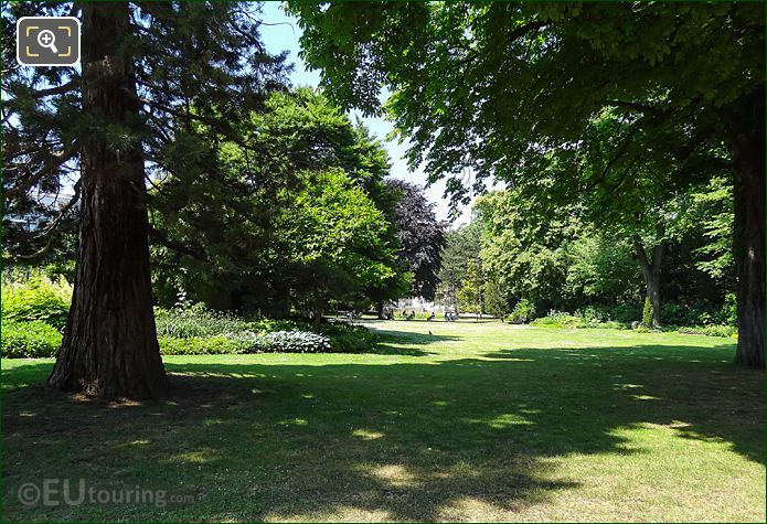 View West through trees and shrubs in Luxembourg Gardens SW corner