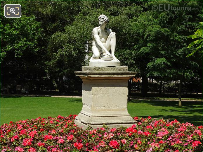 Red flowers around Archidamas statue in Jardin du Luxembourg