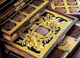 Coins collection in gilded case at Musee des Monnaies