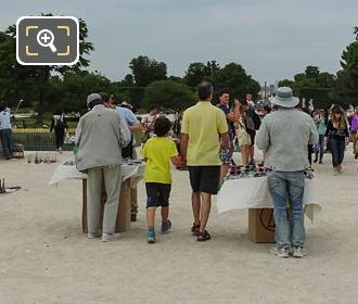 Street Sellers and tourists at steps of Tuileries Garden