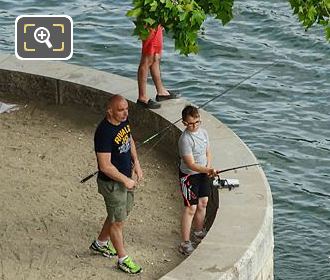 Father and son fishing the River Seine at Quai des Tuileries