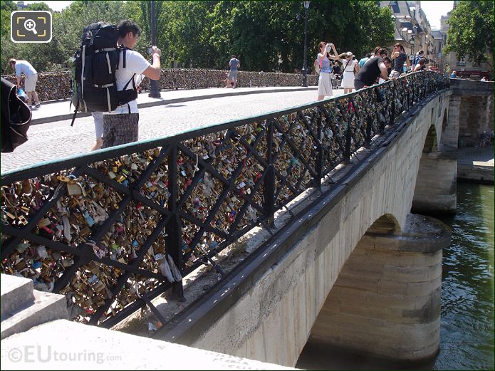 Tourists taking photos of Pont de l'Archeveche