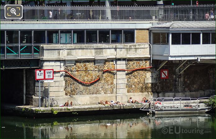 Sunbathers inside Port de l'Arsenal marina