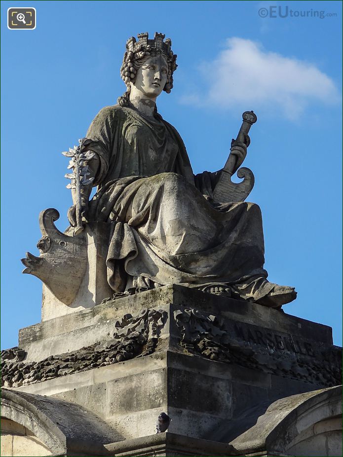 Front and right side of Marseille statue with ship rudder