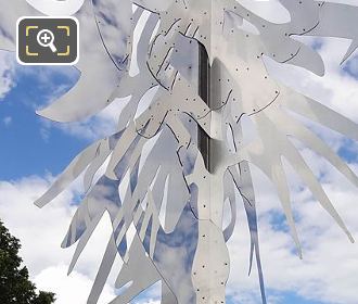 Arbre sculpture with clouds and blue sky