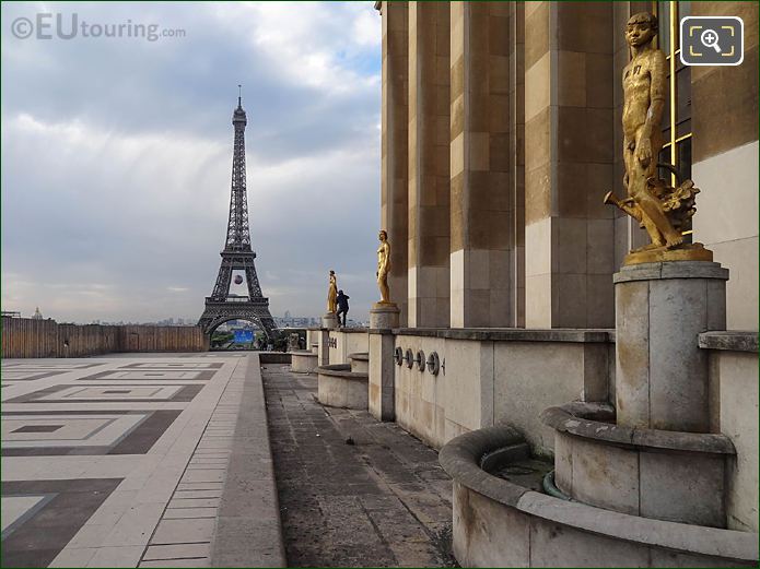 Golden statue Le Jardinier with Eiffel Tower