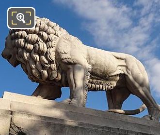 Looking ap at Lion statue on pedestal in Tuileries Gardens
