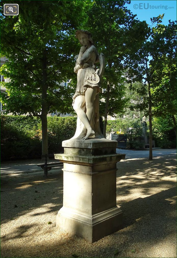 Statue of girl leaning on tree by Maindron