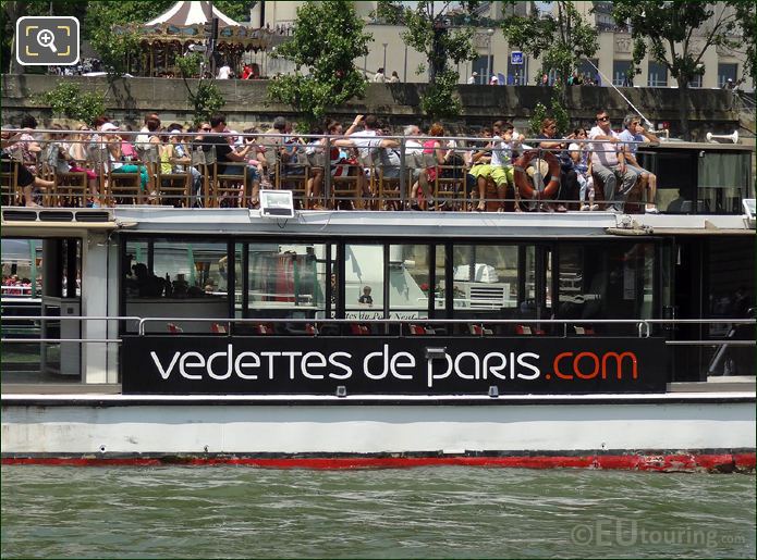 Tourists on top sun deck of Vedettes de Paris boat