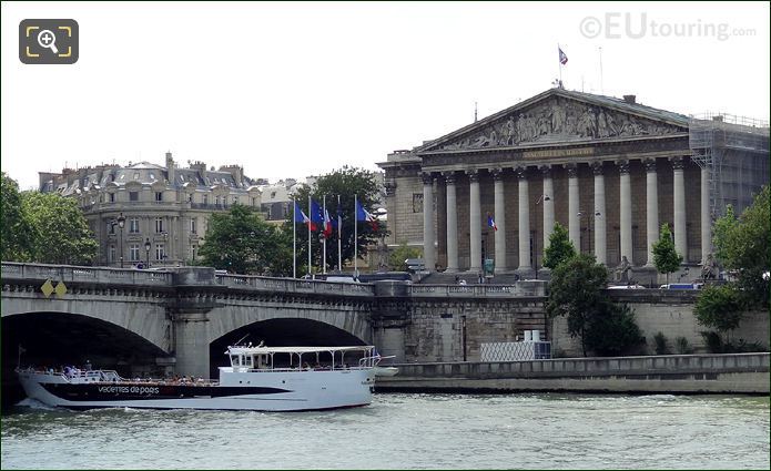 Vedettes de Paris boat passing under a River Seine bridge